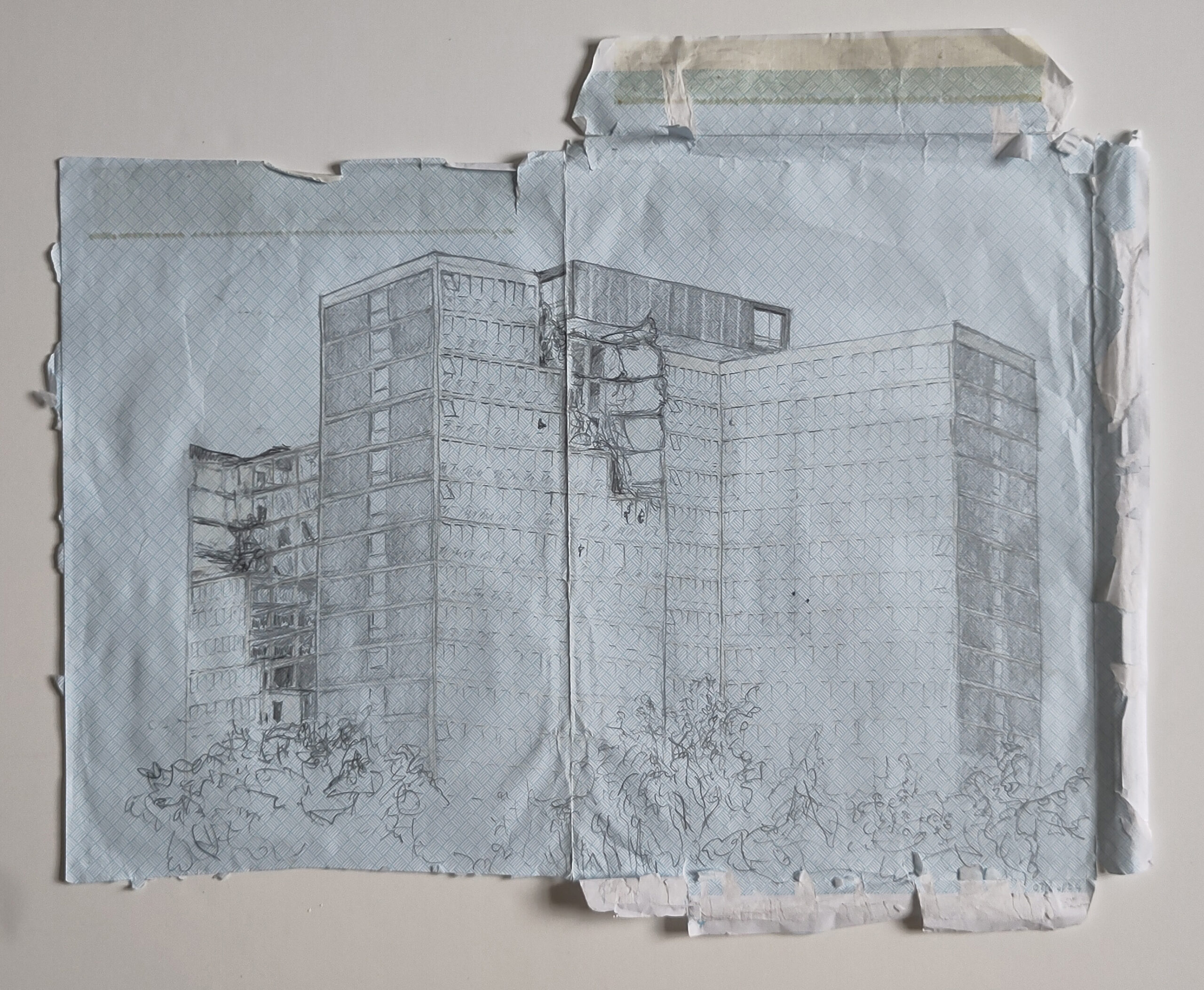 Detailed pencil drawing on the inside of an A4 envelope,of a large, brutalist office block, just starting to be demolished.